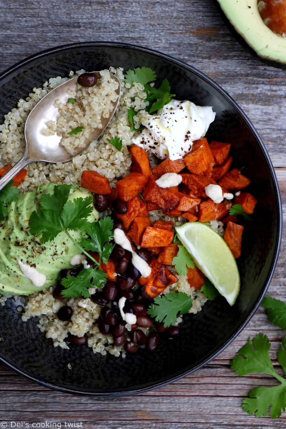 Sweet potato black bean quinoa bowl with tahini dressing makes a nourishing, healthy vegan meal loaded with veggies and plant-based protein.