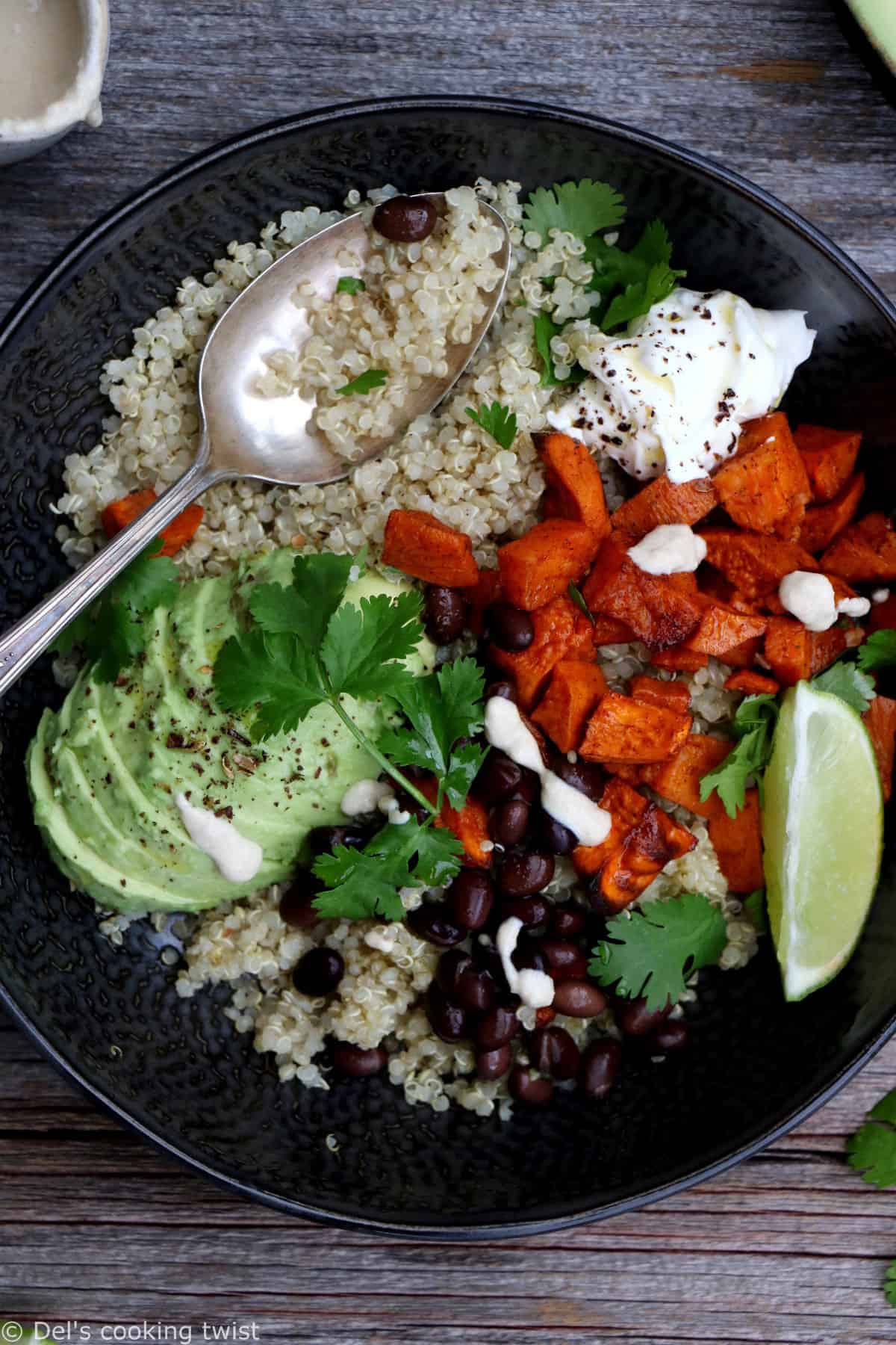 Sweet potato black bean quinoa bowl with tahini dressing makes a nourishing, healthy vegan meal loaded with veggies and plant-based protein.