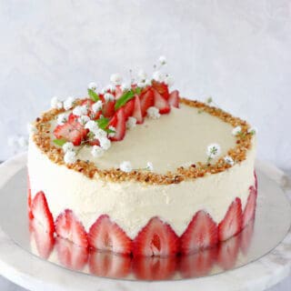 Fraisier cake is a traditional French strawberry cake, consisting of two layers of genoise sponge, filled with a silky delicious vanilla mousseline cream and fresh strawberries.