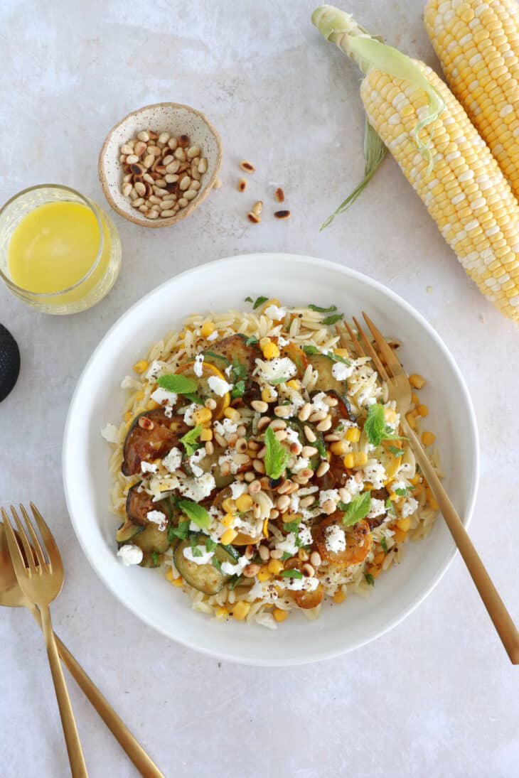 This corn and zucchini orzo salad with goat cheese is tossed together with a cumin vinaigrette and some mint for a very refreshing touch.