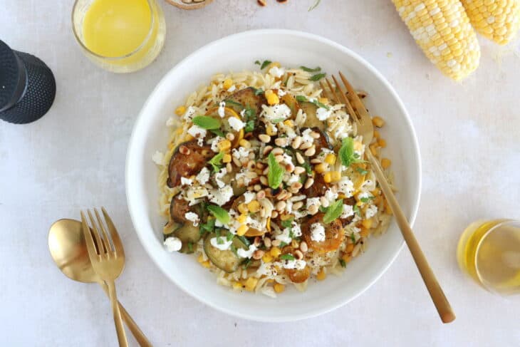 This corn and zucchini orzo salad with goat cheese is tossed together with a cumin vinaigrette and some mint for a very refreshing touch.