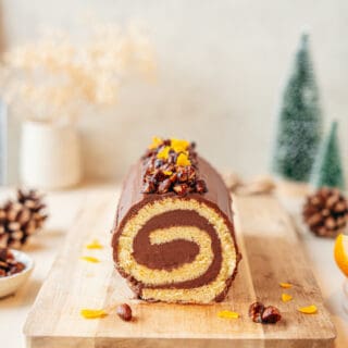 This chocolate orange yule log (or bûche de Noël in French) is a traditional Christmas dessert in France. It consists of a light sponge cake, subtly flavored with orange, and a generous chocolate ganache.