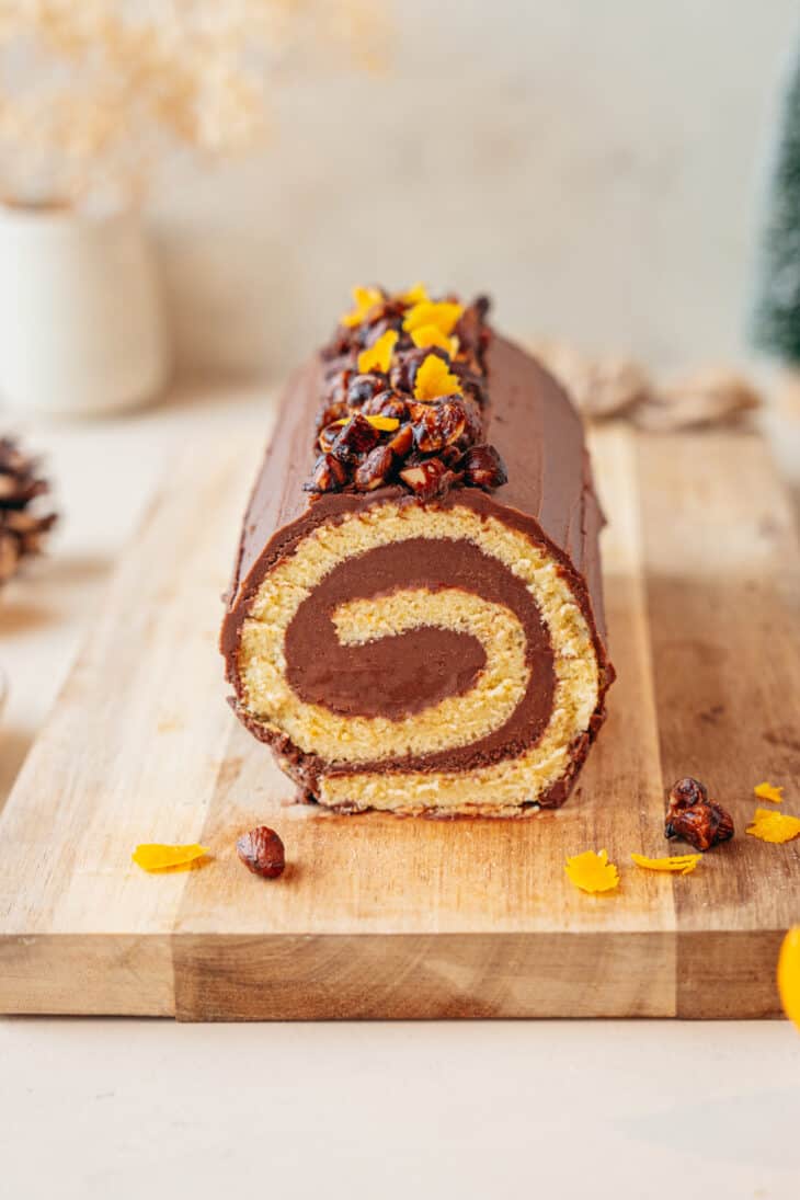 This chocolate orange yule log (or bûche de Noël in French) is a traditional Christmas dessert in France. It consists of a light sponge cake, subtly flavored with orange, and a generous chocolate ganache.