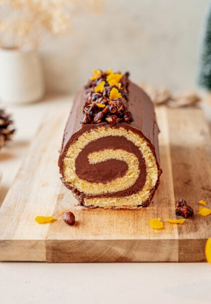 This chocolate orange yule log (or bûche de Noël in French) is a traditional Christmas dessert in France. It consists of a light sponge cake, subtly flavored with orange, and a generous chocolate ganache.