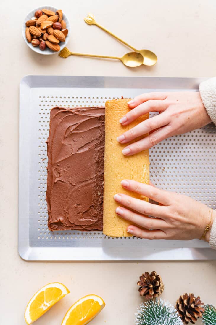 This chocolate orange yule log (or bûche de Noël in French) is a traditional Christmas dessert in France. It consists of a light sponge cake, subtly flavored with orange, and a generous chocolate ganache.