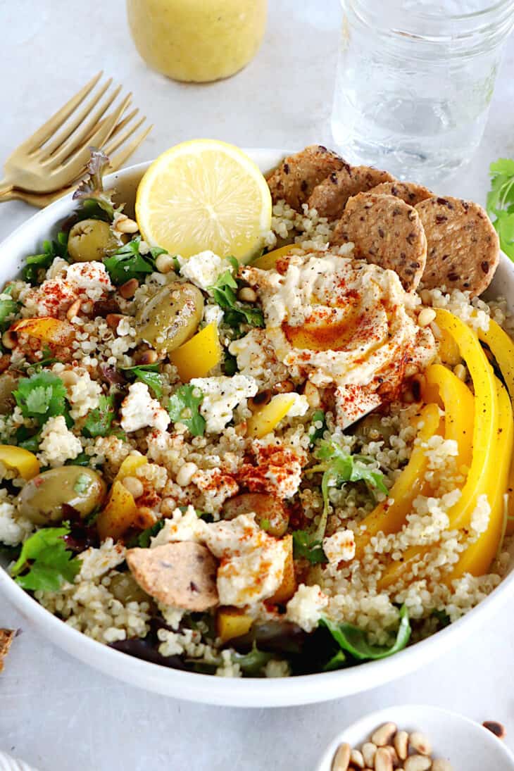 This Mediterranean quinoa salad recipe is as easy as it gets. Both vegetarian and gluten-free, this colorful salad is loaded with veggies.