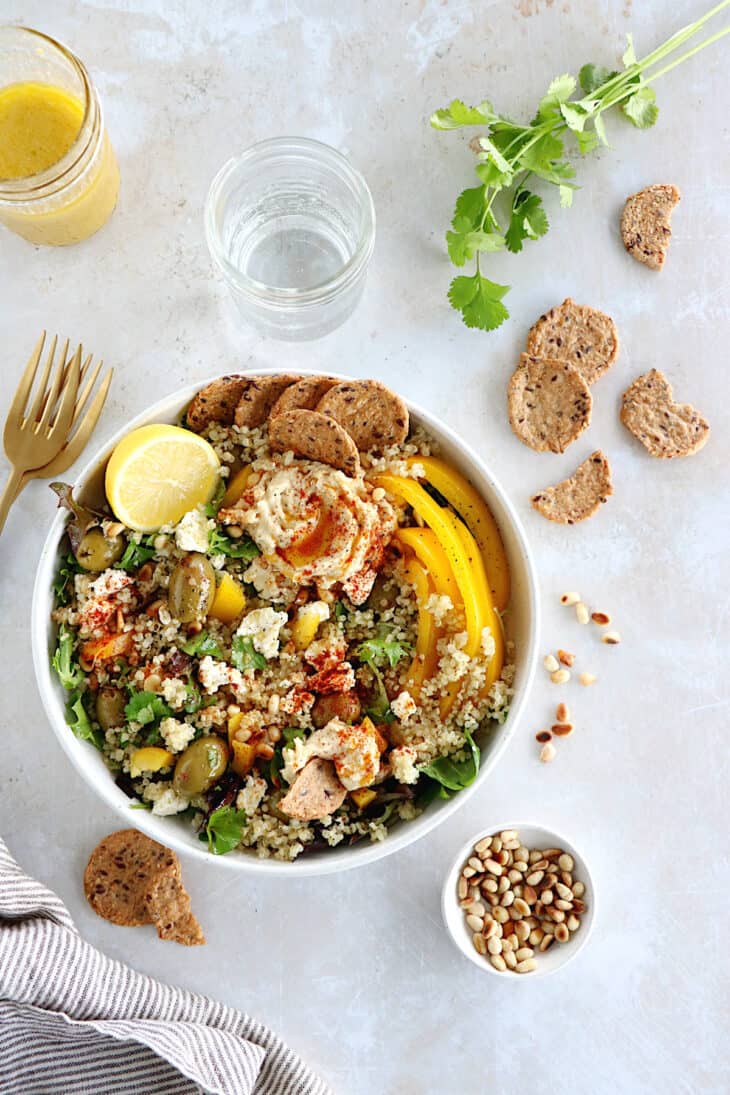 This Mediterranean quinoa salad recipe is as easy as it gets. Both vegetarian and gluten-free, this colorful salad is loaded with veggies.