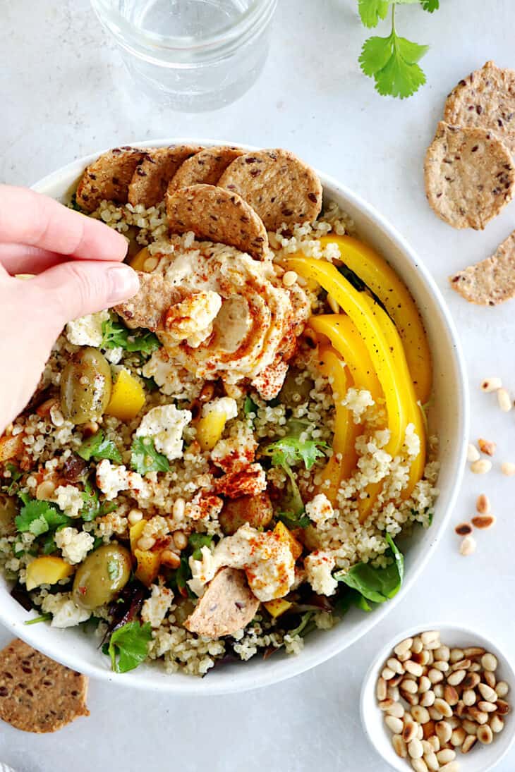 This Mediterranean quinoa salad recipe is as easy as it gets. Both vegetarian and gluten-free, this colorful salad is loaded with veggies.