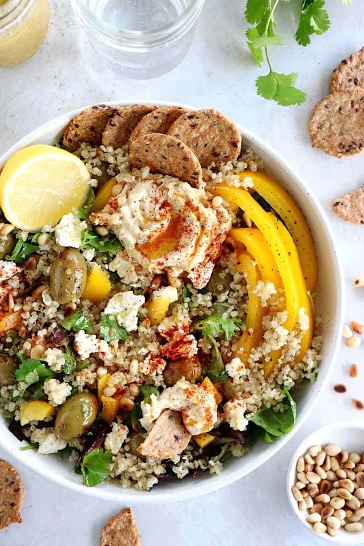 This Mediterranean quinoa salad recipe is as easy as it gets. Both vegetarian and gluten-free, this colorful salad is loaded with veggies.