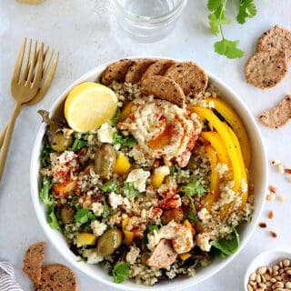 This Mediterranean quinoa salad recipe is as easy as it gets. Both vegetarian and gluten-free, this colorful salad is loaded with veggies.