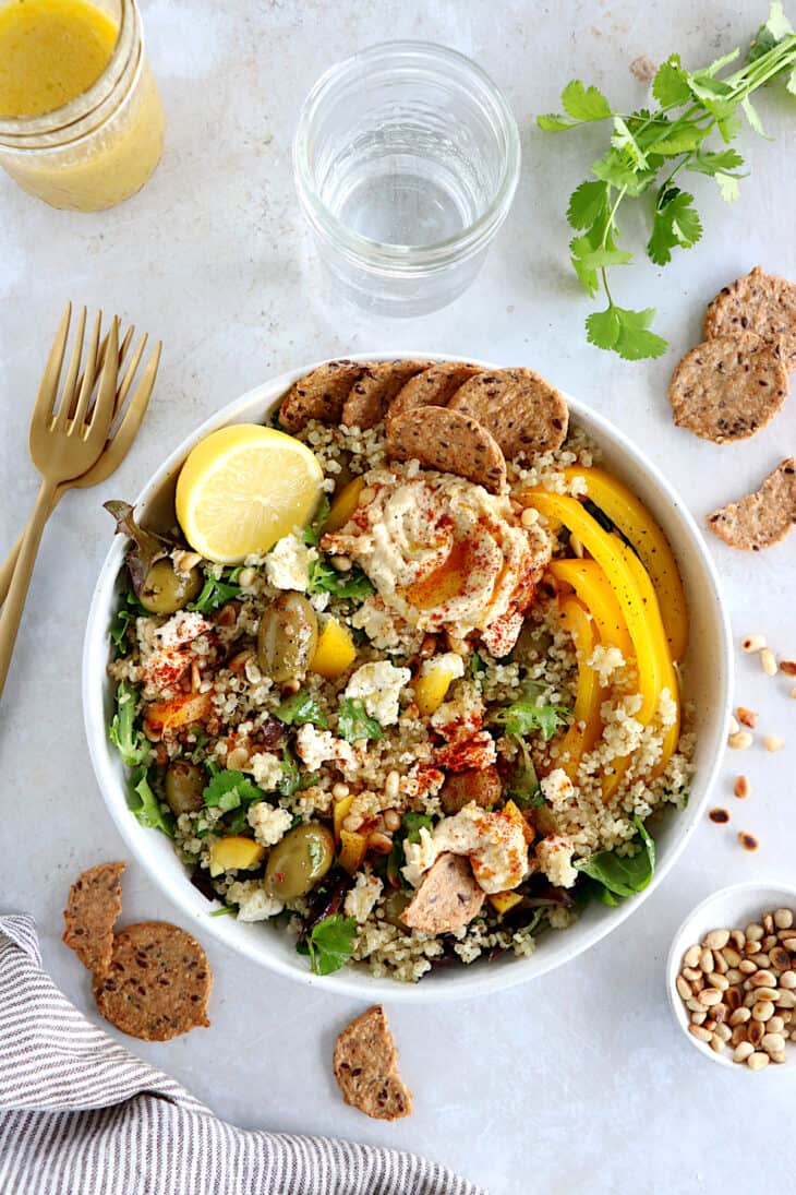 This Mediterranean quinoa salad recipe is as easy as it gets. Both vegetarian and gluten-free, this colorful salad is loaded with veggies.