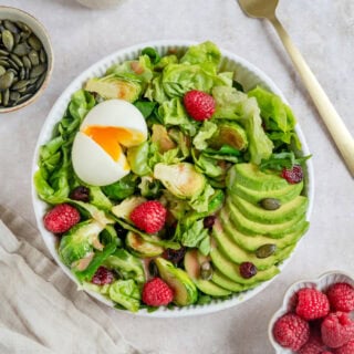 This vibrant avocado raspberry salad with soft-boiled eggs comes with a sweet and subtle raspberry vinaigrette.