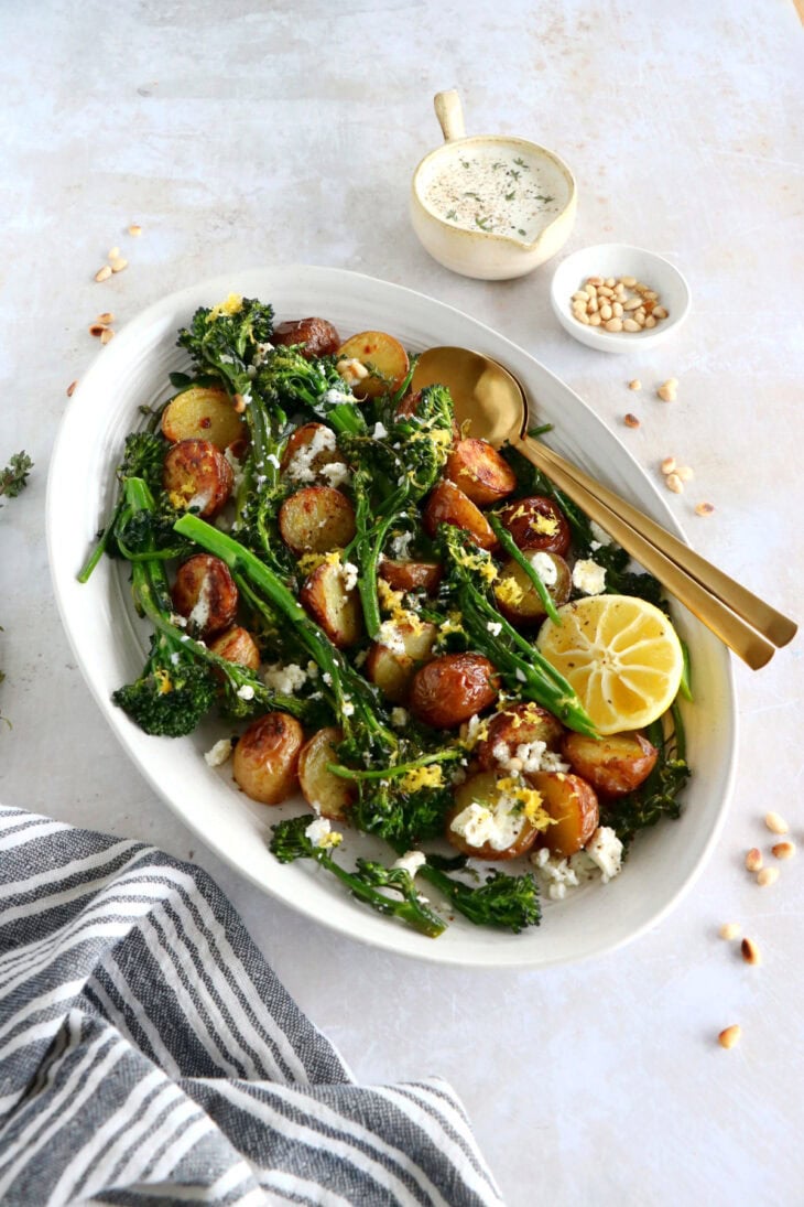 Lemony roasted broccolini and potatoes with feta-yogurt dip is an elegant vegetarian side or main that work for every occasion.