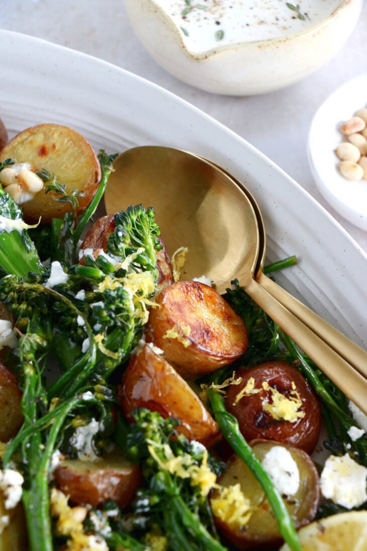 Lemony roasted broccolini and potatoes with feta-yogurt dip is an elegant vegetarian side or main that work for every occasion.
