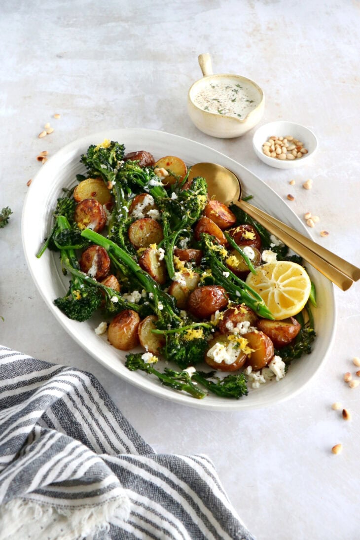 Lemony roasted broccolini and potatoes with feta-yogurt dip is an elegant vegetarian side or main that work for every occasion.