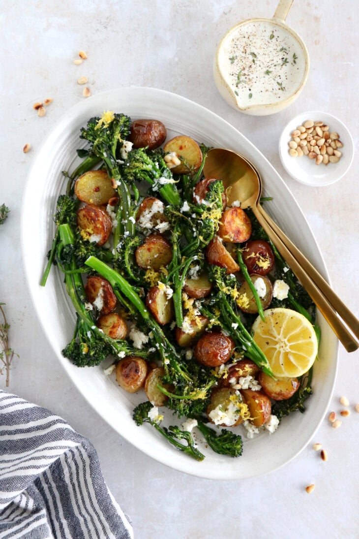 Lemony roasted broccolini and potatoes with feta-yogurt dip is an elegant vegetarian side or main that work for every occasion.