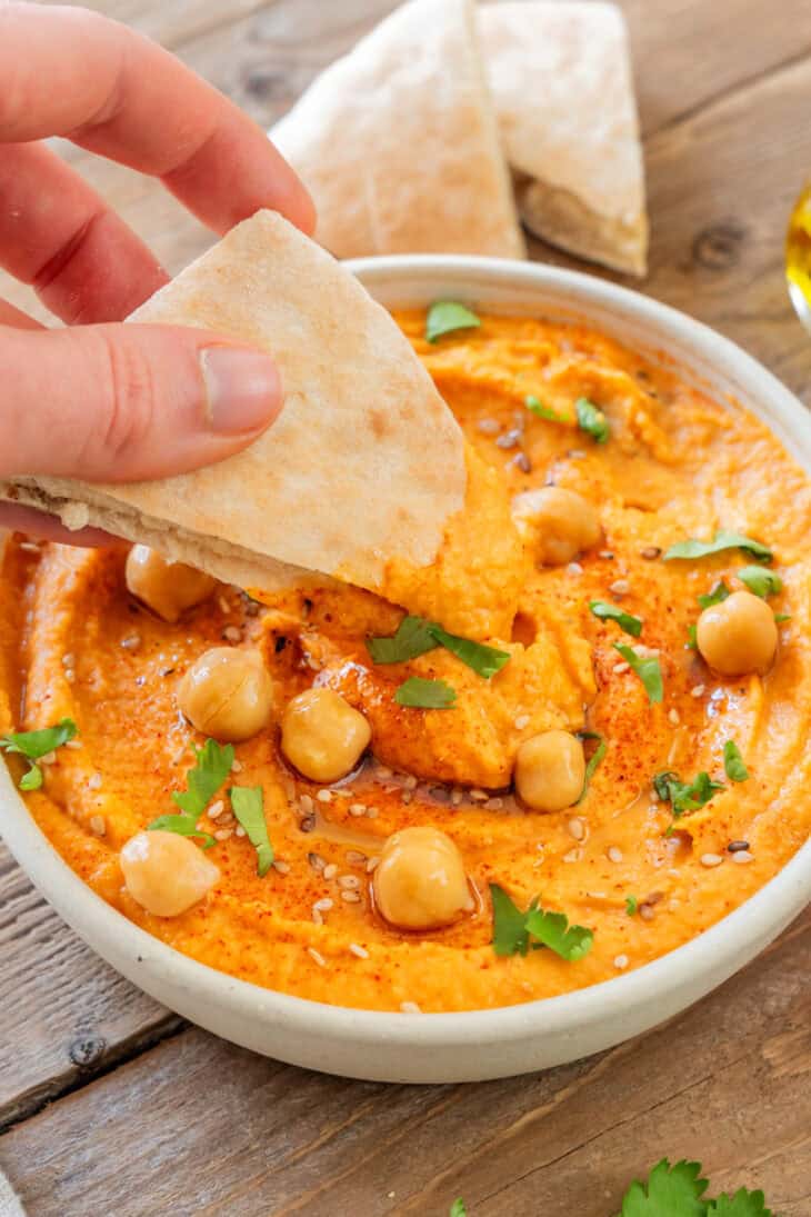 Le houmous aux poivrons grillés est une tartinade aux saveurs douces et fumées, idéale pour l'apéritif avec du pain pita ou des crackers.