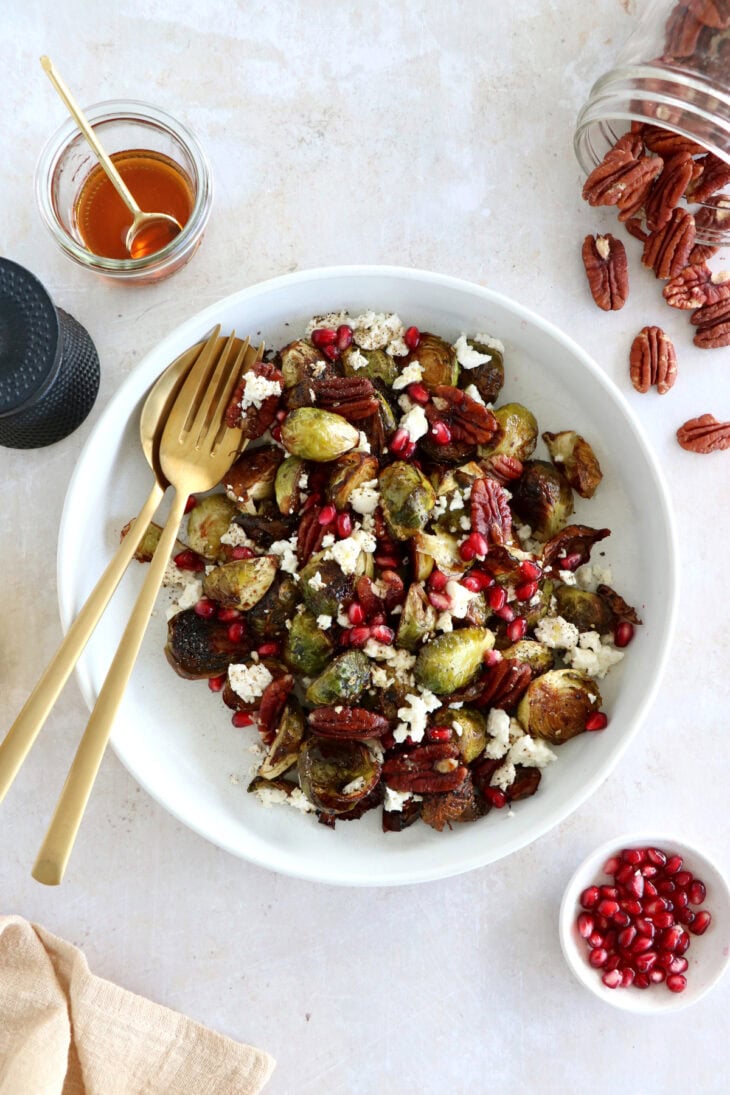 Maple balsamic Brussels sprouts with feta, pomegranate and pecans make a fantastic side dish for the holidays.