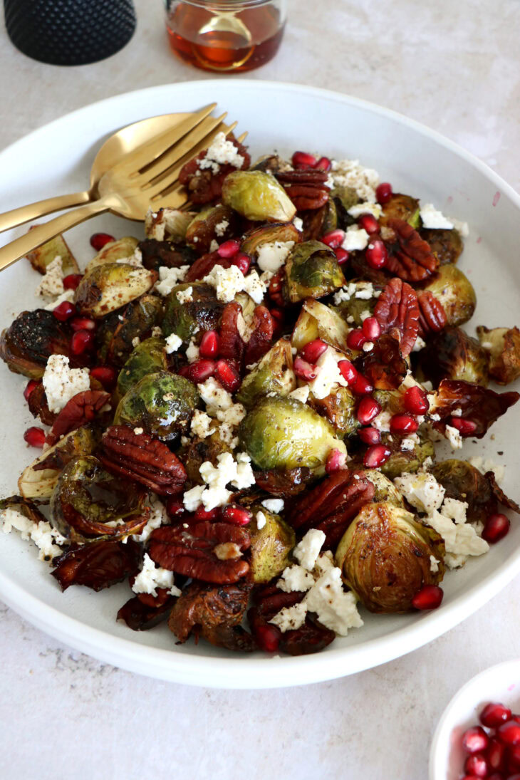 Maple balsamic Brussels sprouts with feta, pomegranate and pecans make a fantastic side dish for the holidays.