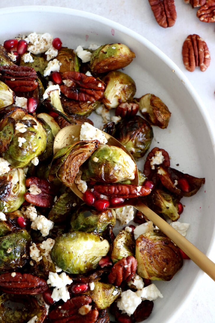 Maple balsamic Brussels sprouts with feta, pomegranate and pecans make a fantastic side dish for the holidays.
