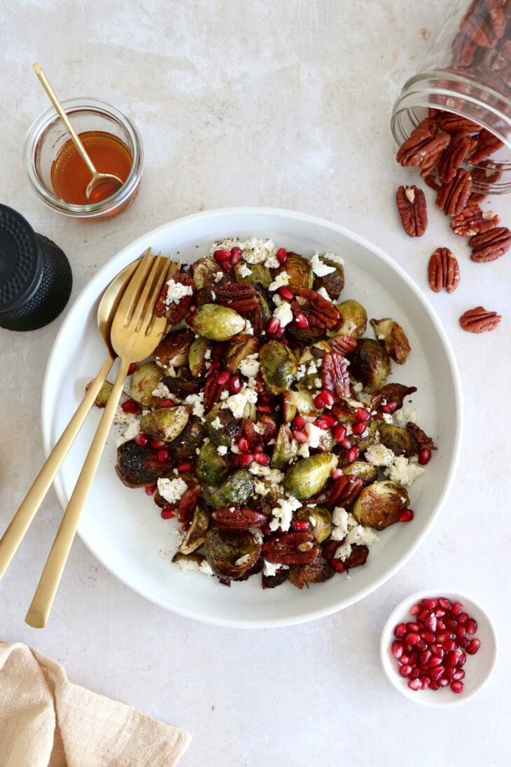 Maple balsamic Brussels sprouts with feta, pomegranate and pecans make a fantastic side dish for the holidays.
