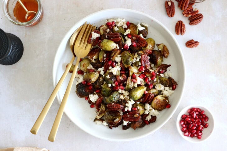 Maple balsamic Brussels sprouts with feta, pomegranate and pecans make a fantastic side dish for the holidays.