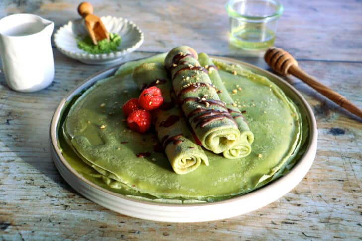 Matcha crêpes are thin, supple, and infused with green tea, bringing a bright green hue and a subtle Asian touch to them.