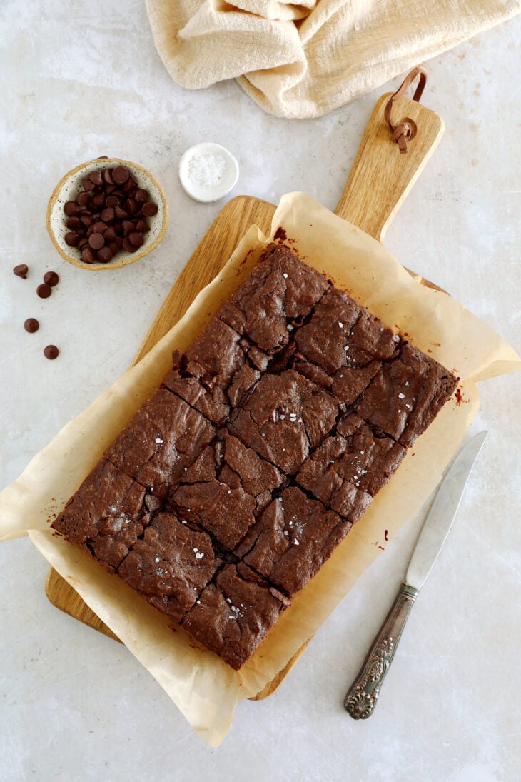 The best fudgy brownies feature a rich and moist chocolate center, with a shiny crackly top on the surface.