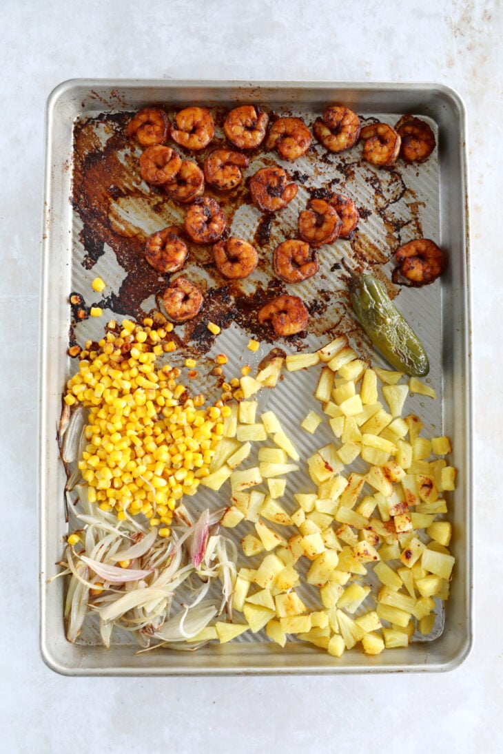 These sheet pan pineapple shrimp tacos with a spicy jalapeño sauce make an easy 20-minute dinner, that tastes better than takeout.
