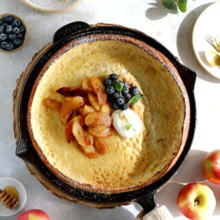 Apple Dutch Baby Pancake - Baked in a large, hot skillet, this giant pancake puffs up like a popover and is topped with caramelized apples.