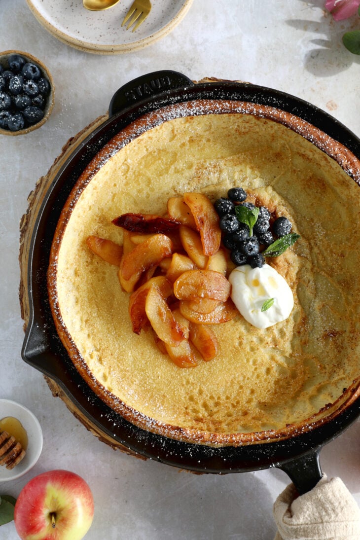 Apple Dutch Baby Pancake - Baked in a large, hot skillet, this giant pancake puffs up like a popover and is topped with caramelized apples.