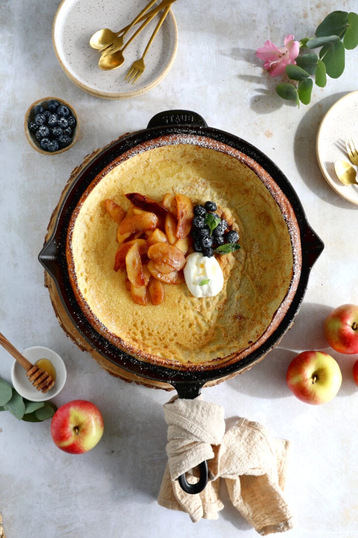 Apple Dutch Baby Pancake - Baked in a large, hot skillet, this giant pancake puffs up like a popover and is topped with caramelized apples.