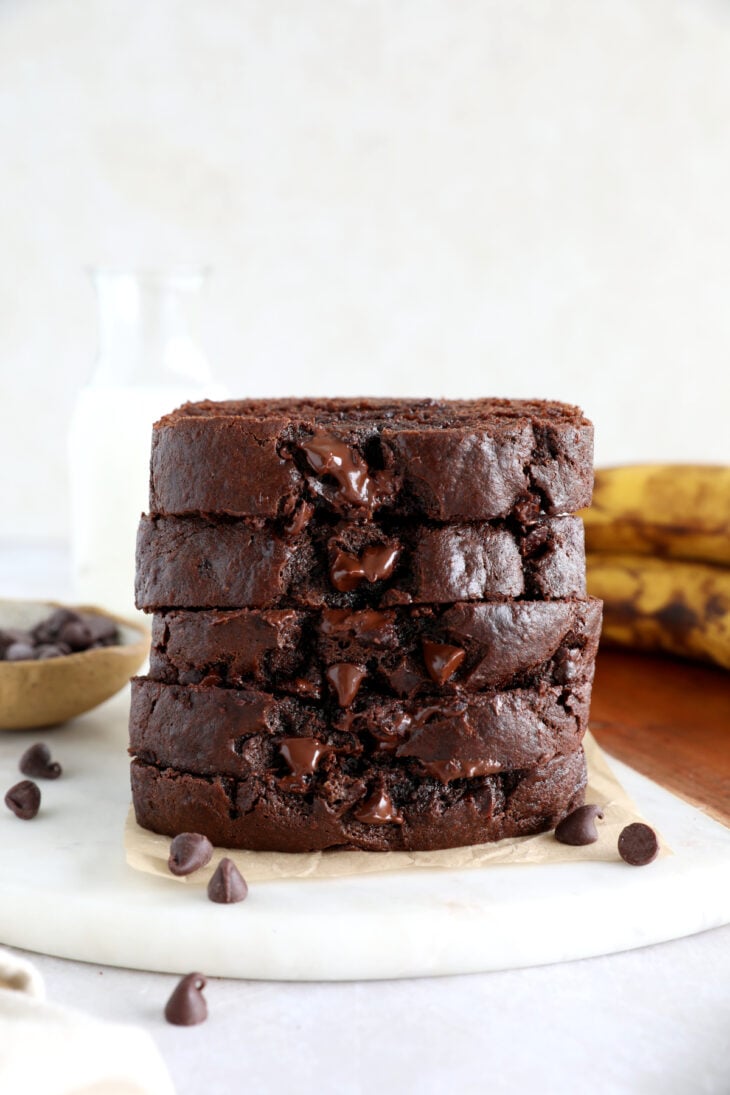 A stack of chocolate banana bread on a cutting board.