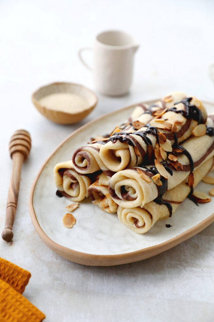 Learn how to make chocolate swirl crepes (zebra crepes). Prepared with a two-tone batter, these chocolate and vanilla crepes are super fun!