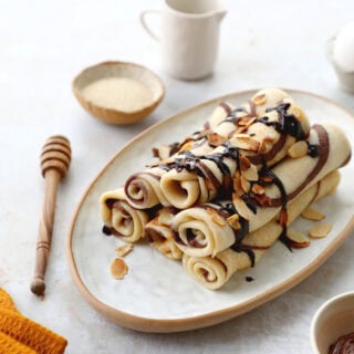 Learn how to make chocolate swirl crepes (zebra crepes). Prepared with a two-tone batter, these chocolate and vanilla crepes are super fun!
