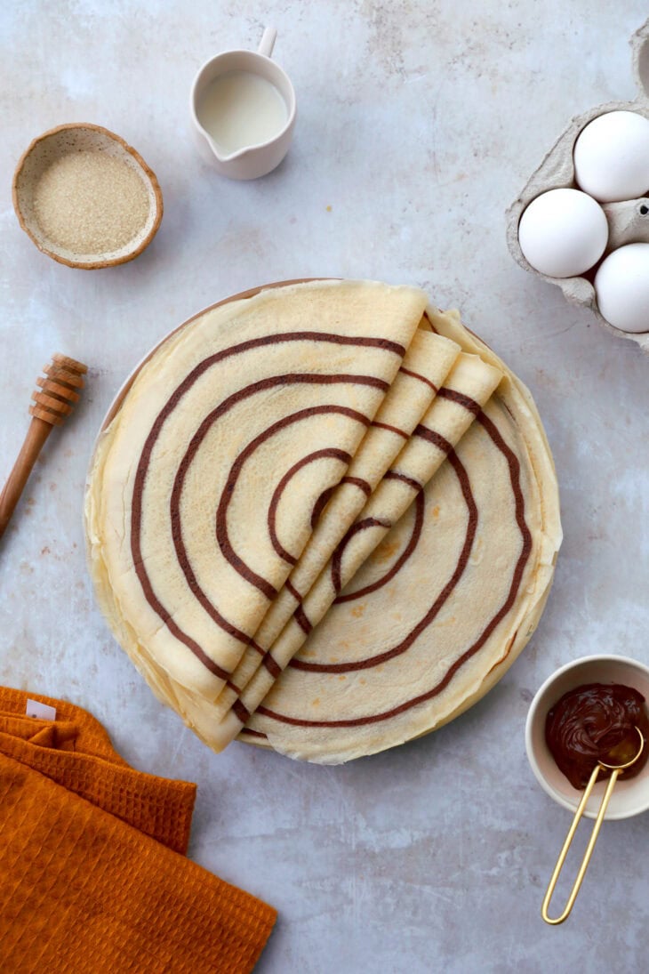 Learn how to make chocolate swirl crepes (zebra crepes). Prepared with a two-tone batter, these chocolate and vanilla crepes are super fun!