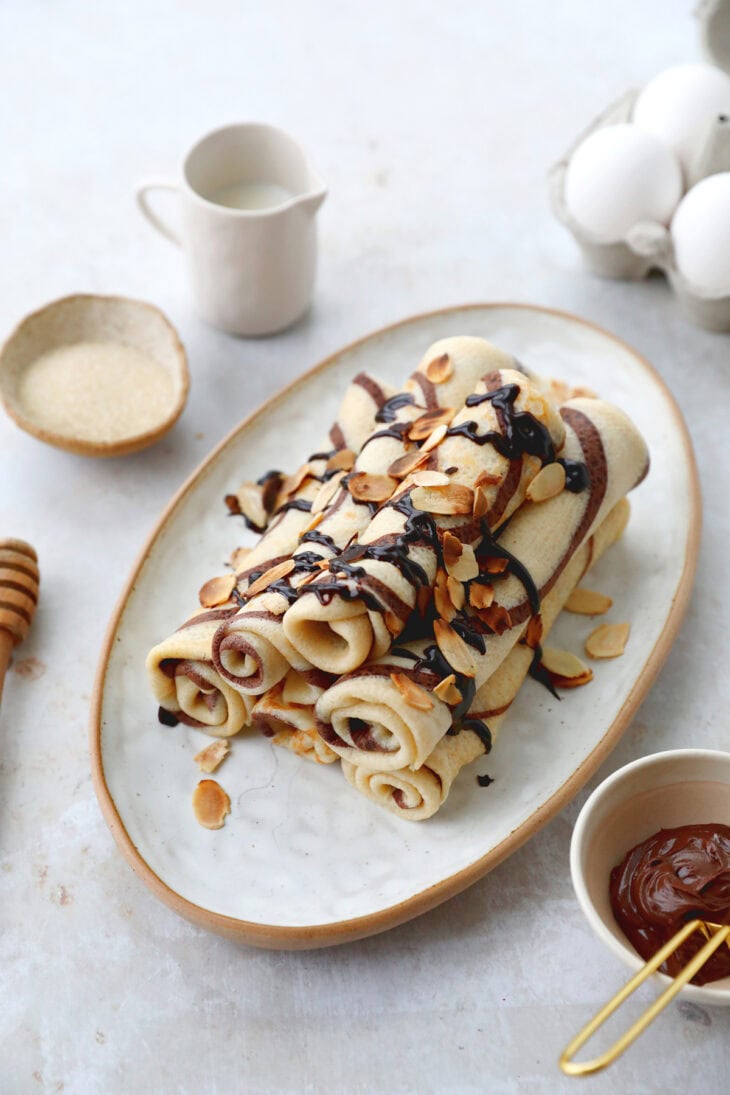 Learn how to make chocolate swirl crepes (zebra crepes). Prepared with a two-tone batter, these chocolate and vanilla crepes are super fun!