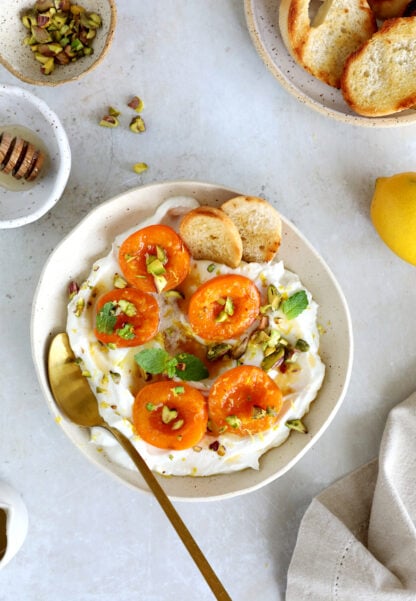 Honey-roasted apricots with whipped ricotta, brown butter and toasted pistachios makes for a simple and elegant summer dessert.