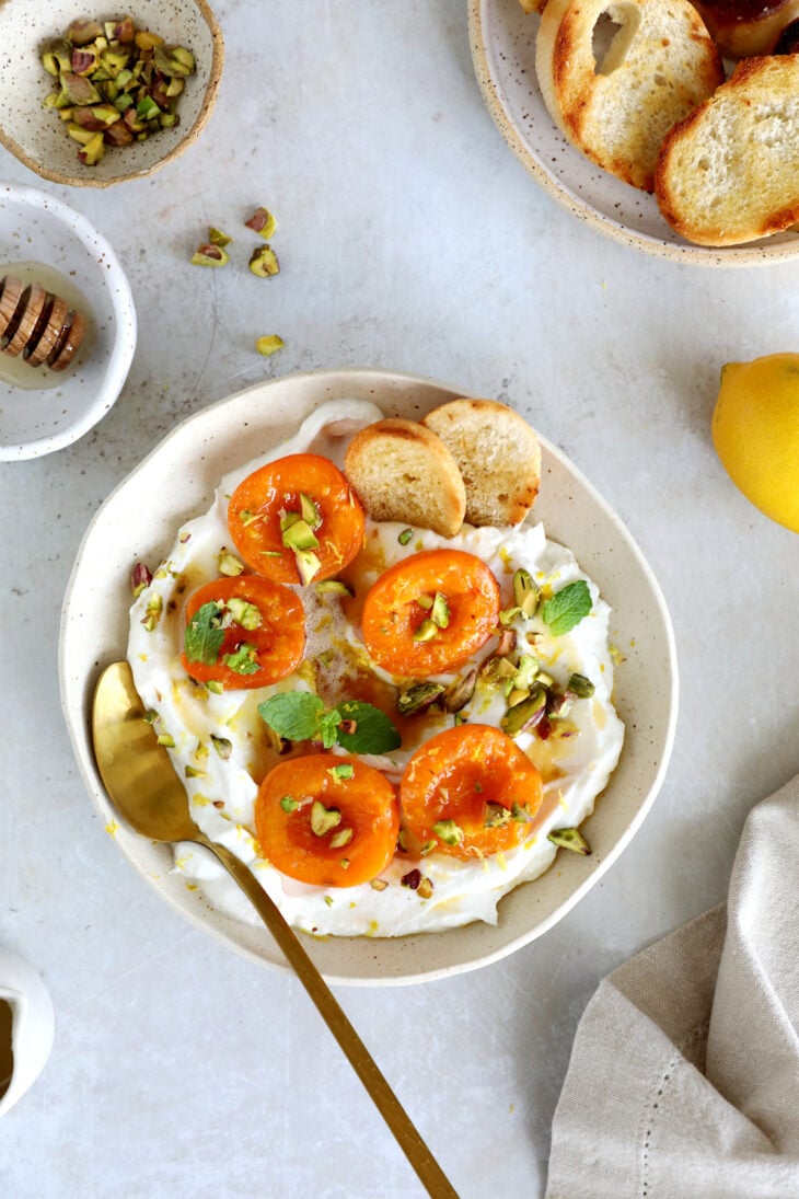 Honey-roasted apricots with whipped ricotta, brown butter and toasted pistachios makes for a simple and elegant summer dessert.