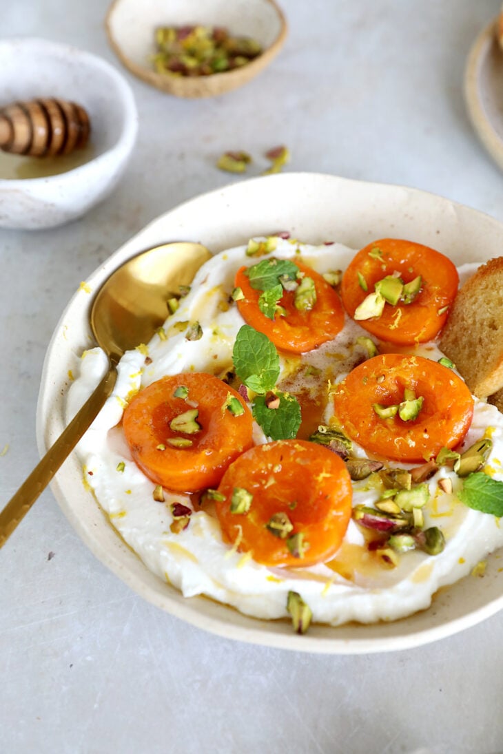 Honey-roasted apricots with whipped ricotta, brown butter and toasted pistachios makes for a simple and elegant summer dessert.