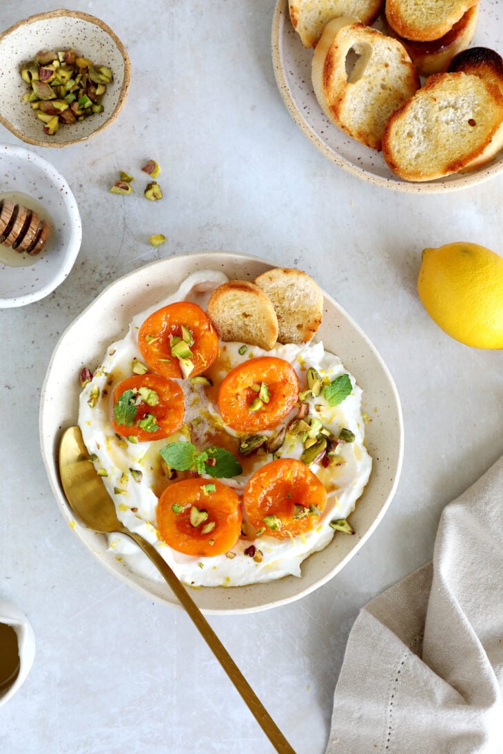Honey-roasted apricots with whipped ricotta, brown butter and toasted pistachios makes for a simple and elegant summer dessert.