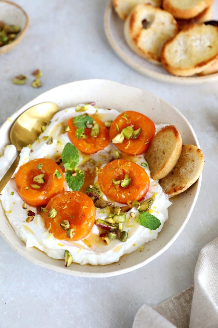 Honey-roasted apricots with whipped ricotta, brown butter and toasted pistachios makes for a simple and elegant summer dessert.