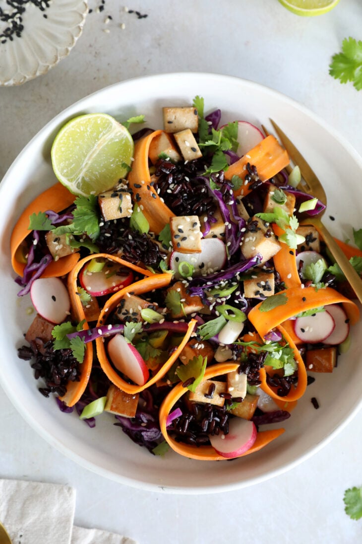 This Asian-inspired tofu salad combines black rice, crunchy vegetables and smoked tofu, tossed together in a subtle miso dressing.