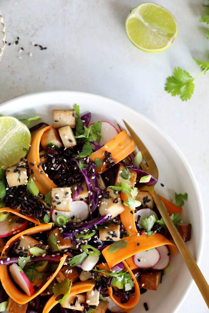 This Asian-inspired tofu salad combines black rice, crunchy vegetables and smoked tofu, tossed together in a subtle miso dressing.