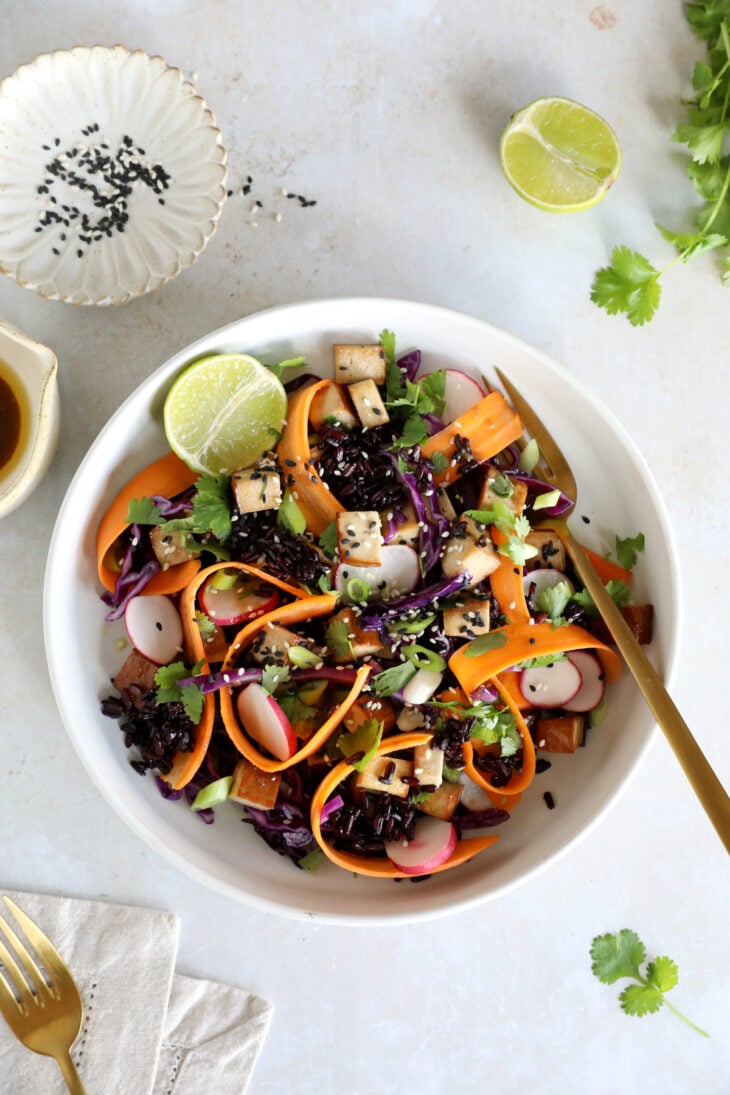 This Asian-inspired tofu salad combines black rice, crunchy vegetables and smoked tofu, tossed together in a subtle miso dressing.