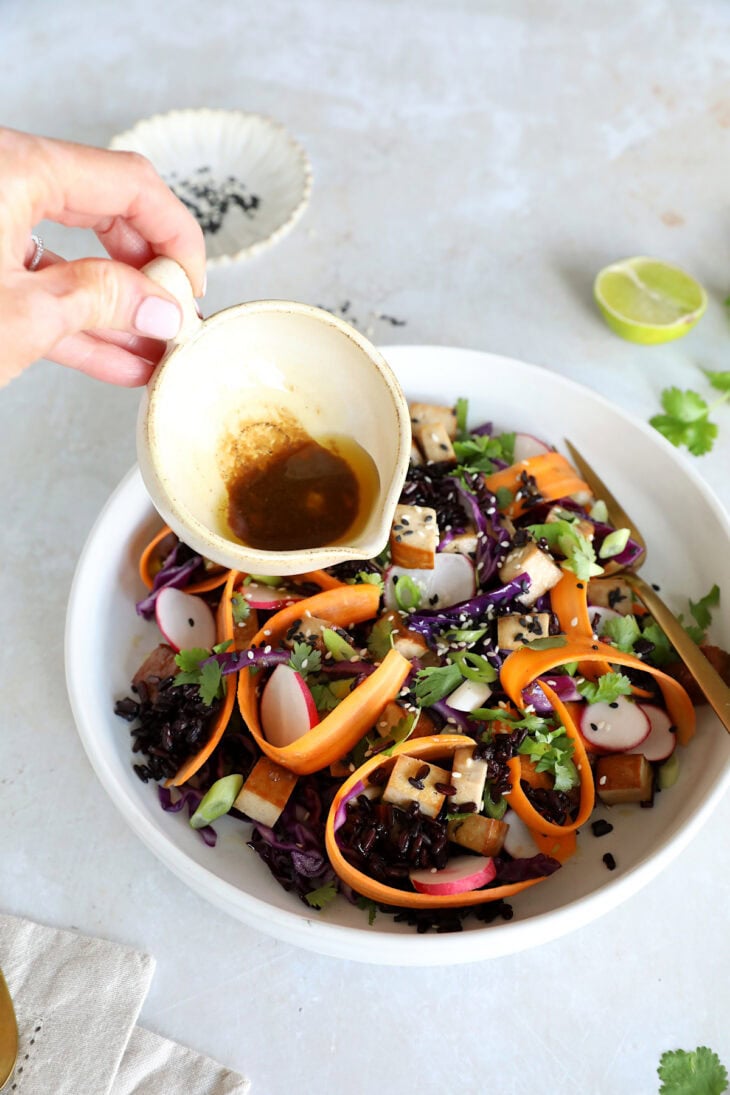This Asian-inspired tofu salad combines black rice, crunchy vegetables and smoked tofu, tossed together in a subtle miso dressing.