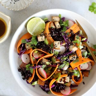 This Asian-inspired tofu salad combines black rice, crunchy vegetables and smoked tofu, tossed together in a subtle miso dressing.