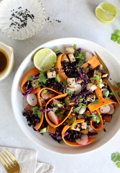 This Asian-inspired tofu salad combines black rice, crunchy vegetables and smoked tofu, tossed together in a subtle miso dressing.