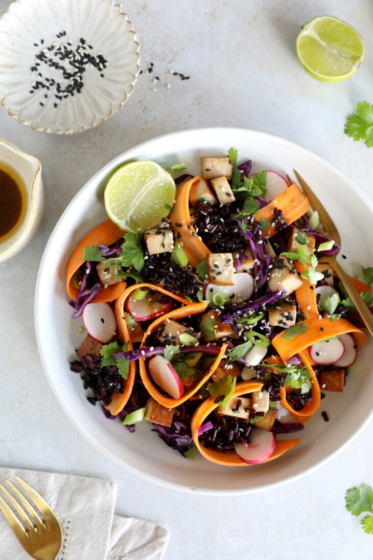This Asian-inspired tofu salad combines black rice, crunchy vegetables and smoked tofu, tossed together in a subtle miso dressing.