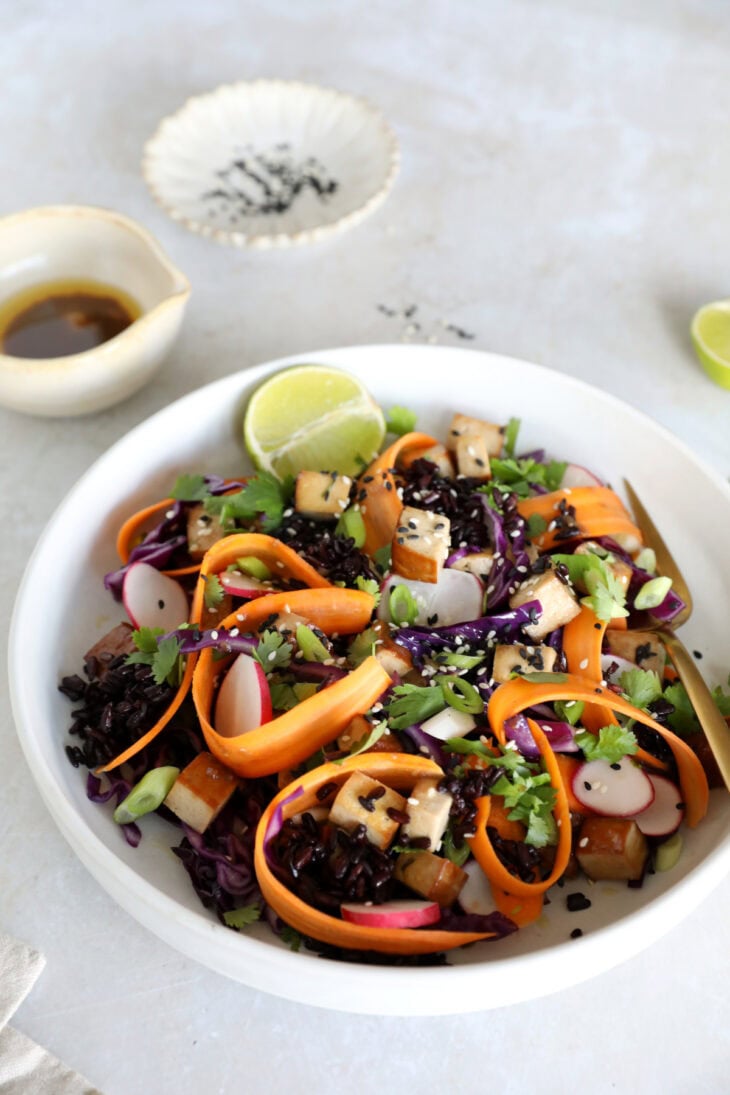 This Asian-inspired tofu salad combines black rice, crunchy vegetables and smoked tofu, tossed together in a subtle miso dressing.